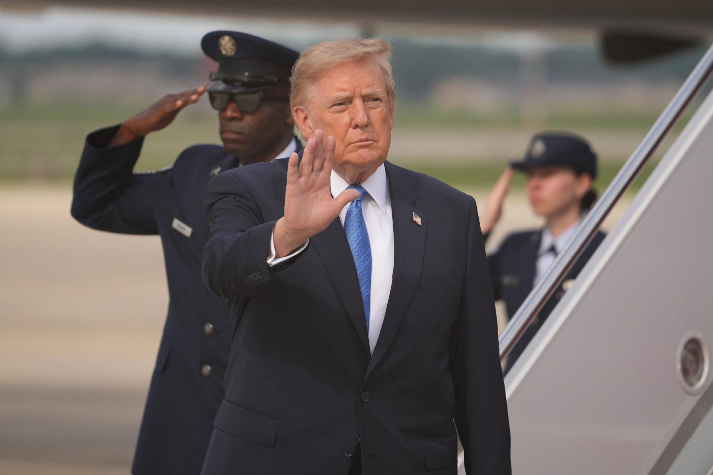 President Donald Trump waves after arriving off Air Force One, Friday, Aug. 28, 2026, at Joint Base Andrews, Md.